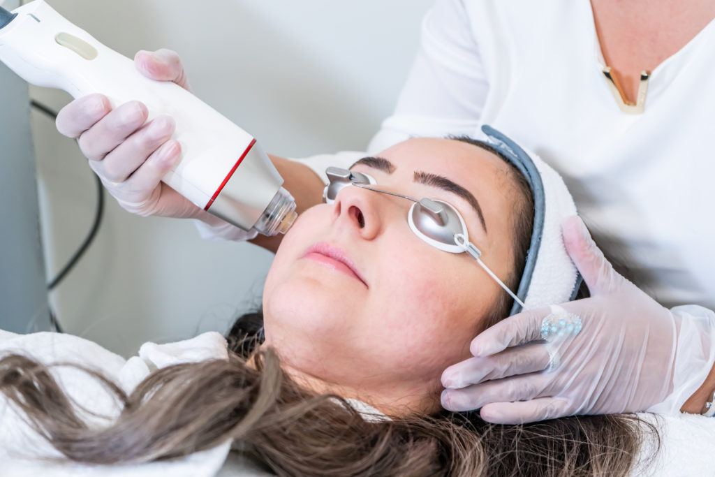 The doctor treating face of a Lady | Know about Lutronic Laser Therapy at Arabella Medical Aesthetics in Knoxville, TN