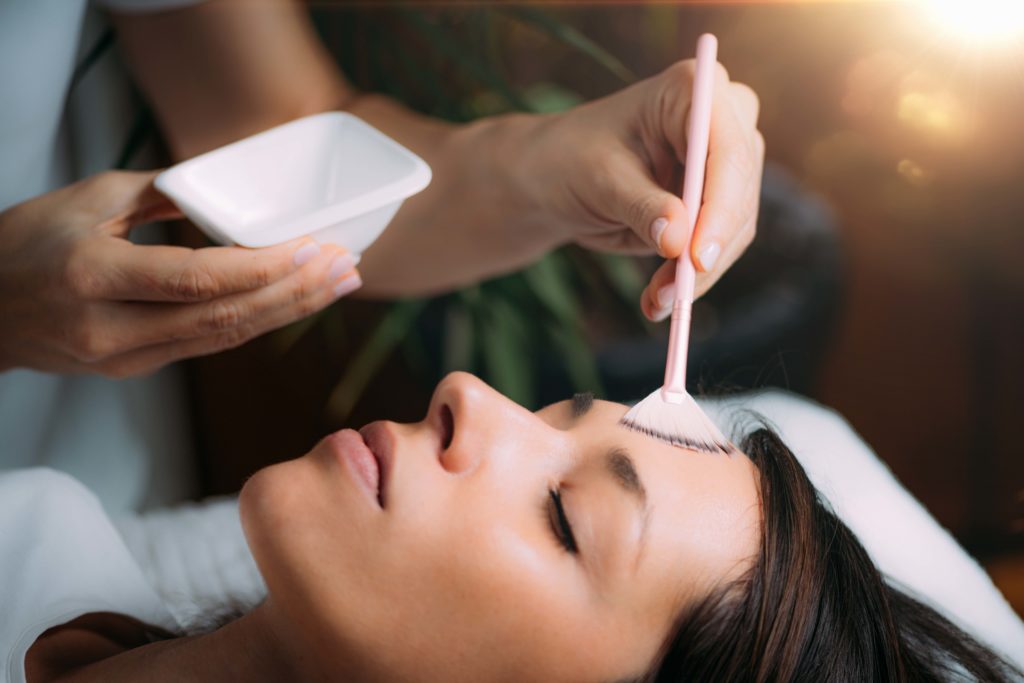A Woman getting peels on forehead | Get Chemical Peels at Arabella Medical Aesthetics in Knoxville, TN